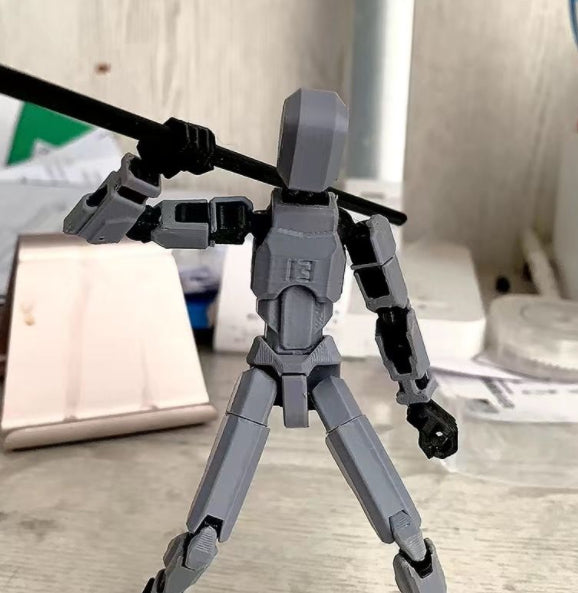 Orange 3D-printad robotfigur i pose