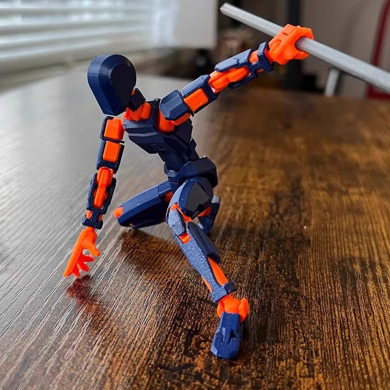 Orange 3D-printad robotfigur i pose